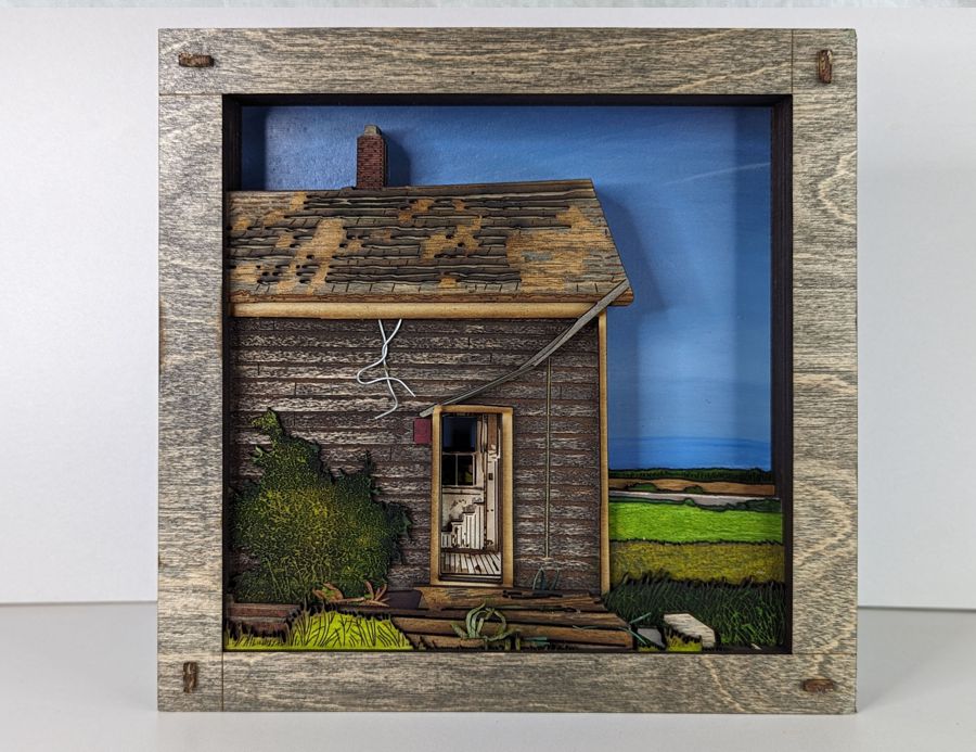 Dimensional wall art of a wood cabin